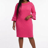 Plus-size model wears a fuchsia textured sheath dress with sheer stripe accents at the chest and flared bell sleeves, front