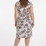 Plus-size model shown from back wearing a knee-length blush geometric-print cap-sleeve belted dress with fitted waist.