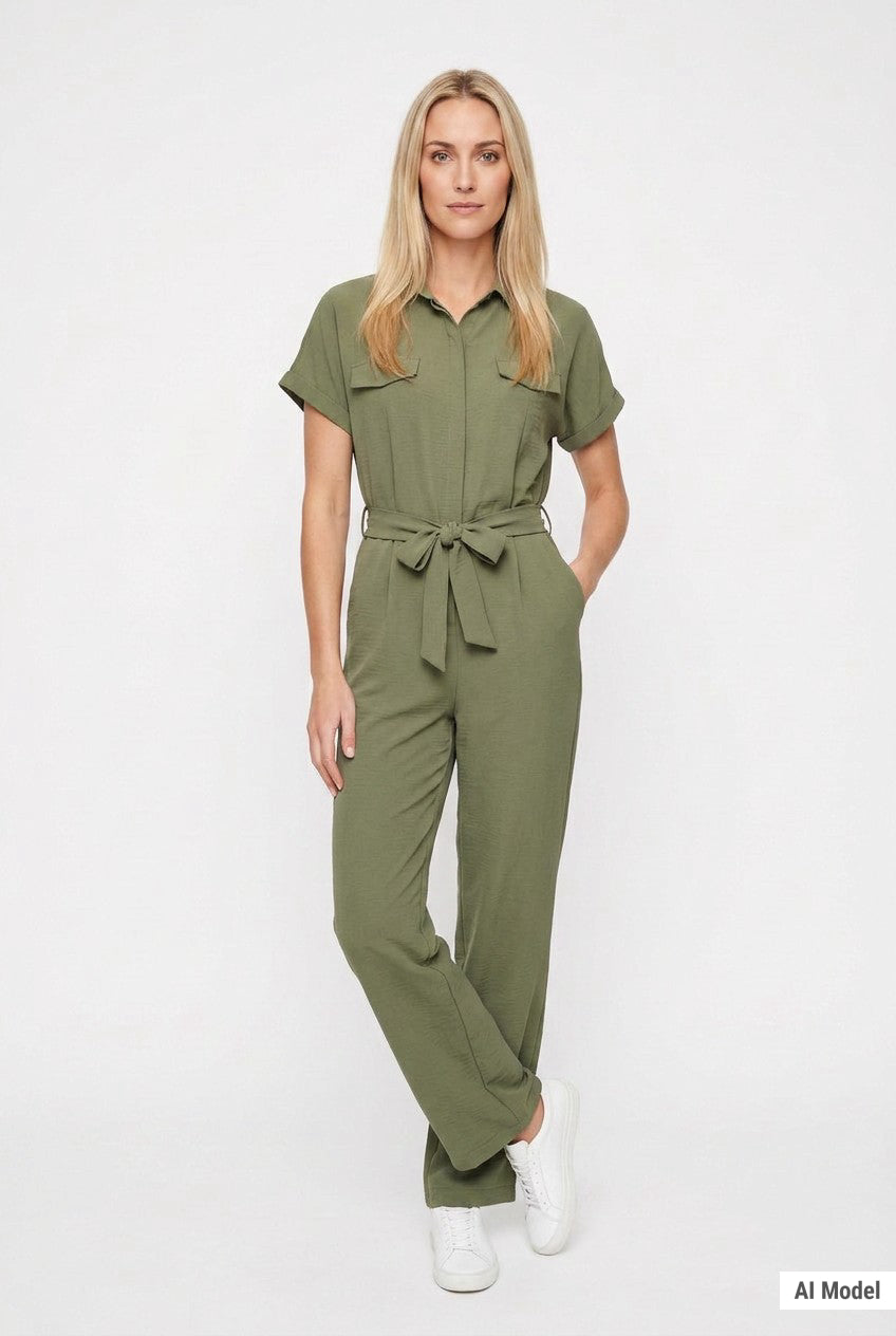 Blonde female model wearing an olive green short-sleeve belted jumpsuit with collar, chest pockets, and wide-leg pants;