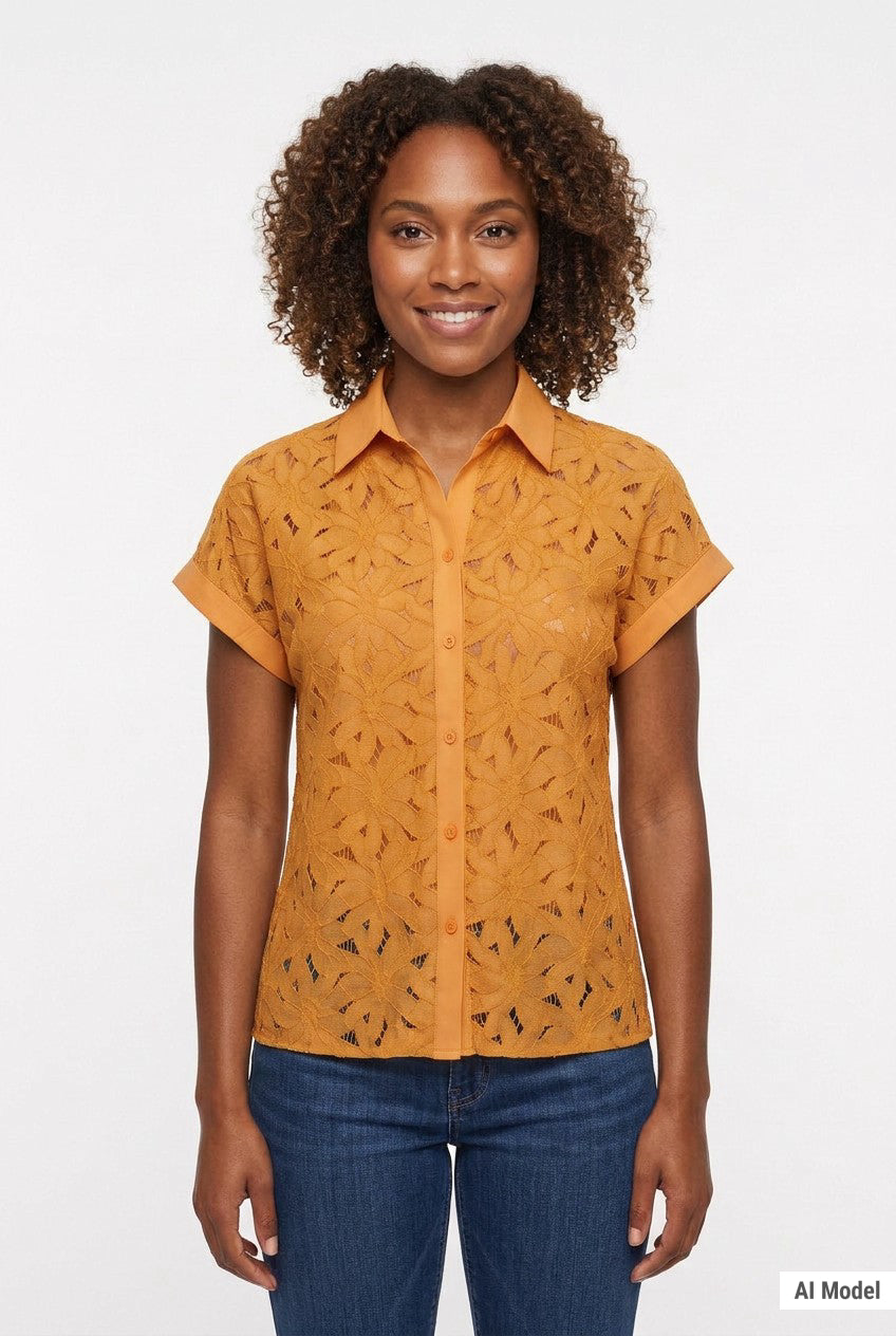Woman wearing a golden orange short-sleeve eyelet button-front blouse with collar and cuffed sleeves, paired with dark