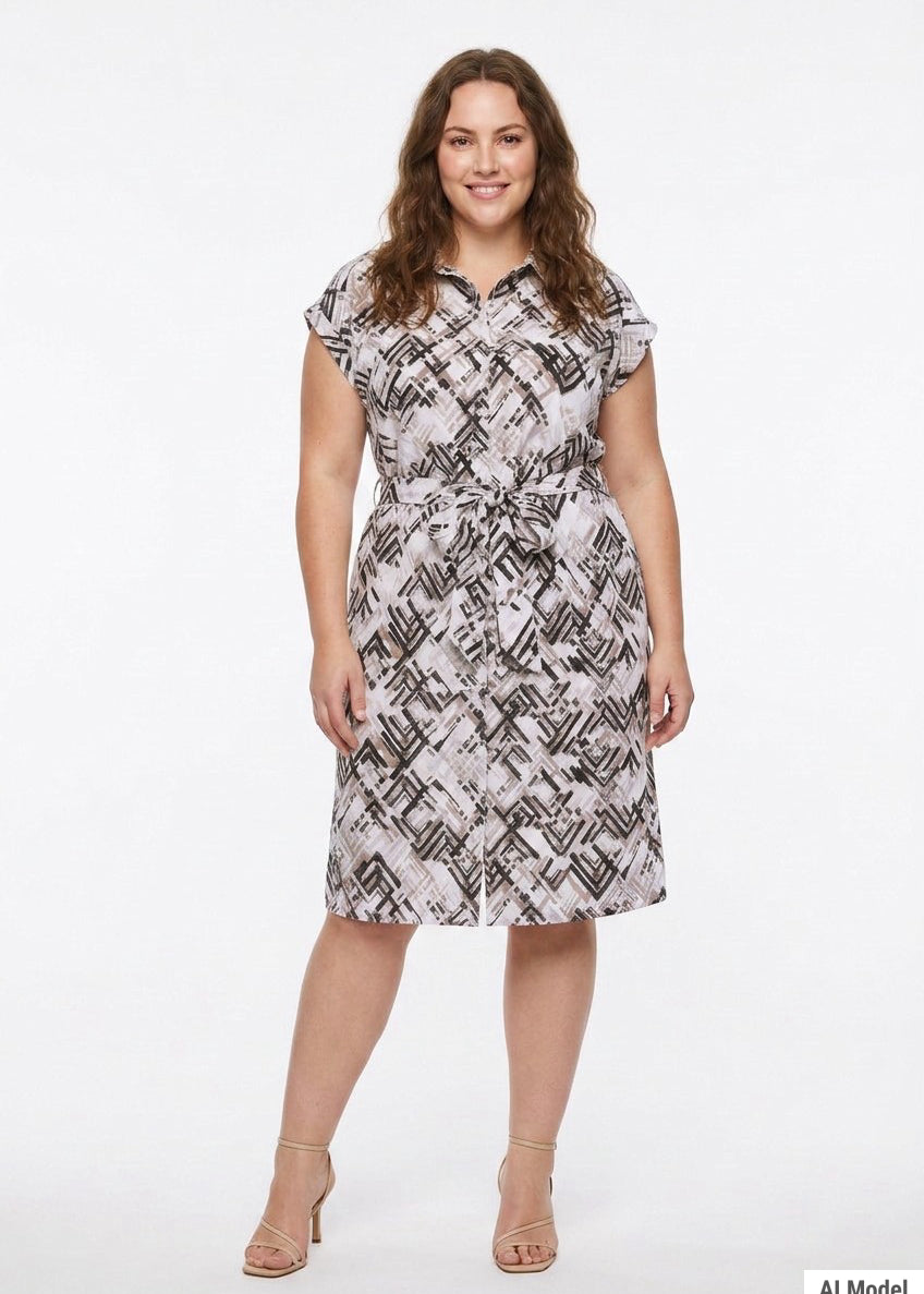 Plus-size model wears a knee-length geometric print shirtdress with collar, cap sleeves, and self-tie belt, front view.