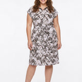 Plus-size model wears a knee-length geometric print shirtdress with collar, cap sleeves, and self-tie belt, front view.