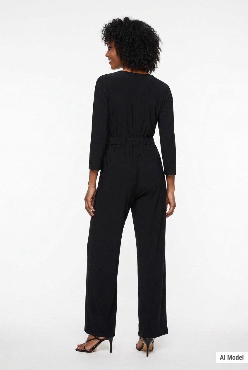 Black 3/4-sleeve wide-leg belted jumpsuit with elastic waist shown from the back on a woman wearing strappy heels.