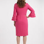 Woman wearing a hot pink textured sheath dress with tiered bell sleeves featuring sheer contrast stripe panels, knee-length,