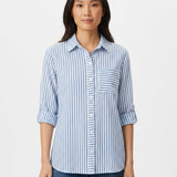 Woman wearing a blue and white vertical-stripe button-front blouse with roll-tab 3/4 sleeves and chest pocket, front view,