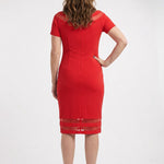 Red short-sleeve sheath dress with sheer mesh shoulder and hem insets, worn by a woman, back view, knee length.