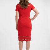 Red short-sleeve sheath dress with sheer mesh shoulder and hem insets, worn by a woman, back view, knee length.
