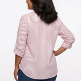 Back view of a woman wearing a pink and white vertical-stripe roll-tab 3/4-sleeve blouse with back yoke, paired with dark
