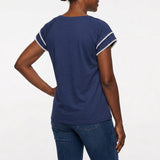 Navy blue short-sleeve top with white pom-pom trim on layered flutter sleeves, worn with dark jeans; back view of a Black