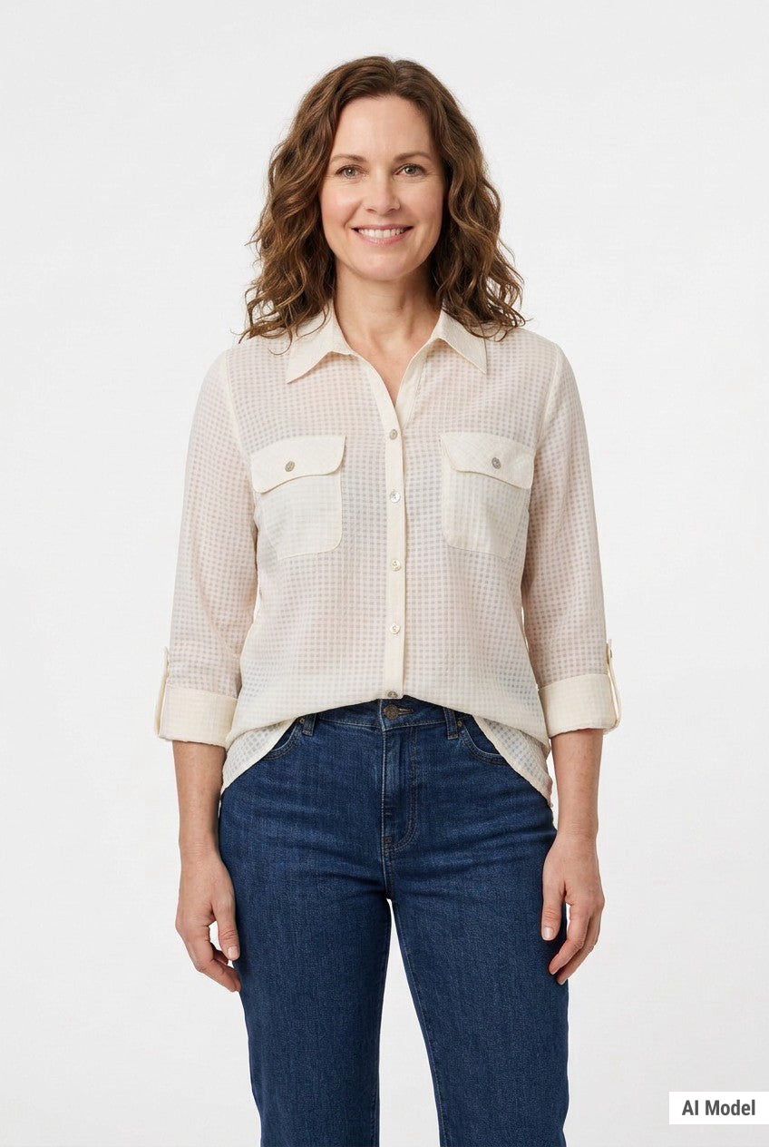 Woman wearing an ivory windowpane button-front blouse with roll-tab 3/4 sleeves and dual chest pockets, front view, waist up.