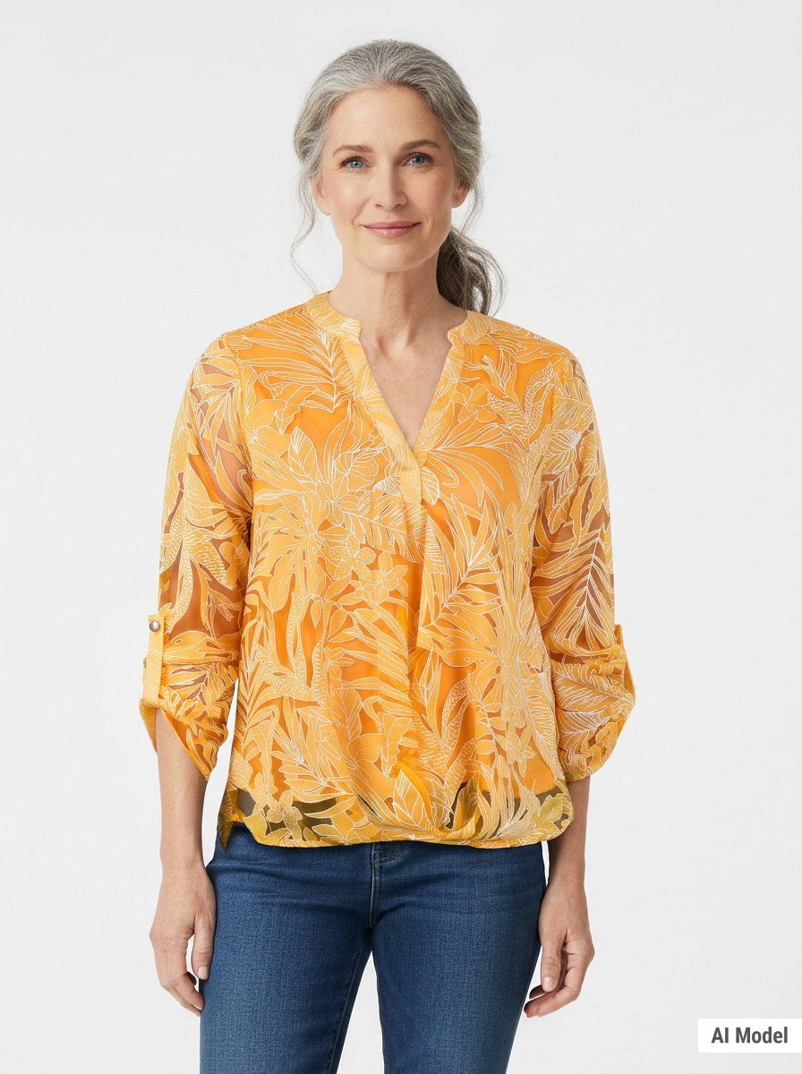 Woman with gray hair models a NY Collection orange tropical-print burnout blouse with V-neck and roll-tab sleeves, paired