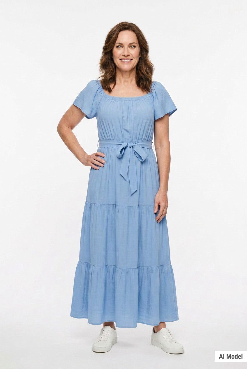 Light blue short-sleeve tiered maxi dress with square neckline and self-tie waist belt, worn by a woman with brown hair,