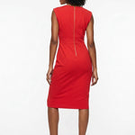 Back view of a red sleeveless sheath dress with gold back zipper, midi length, worn by a Black woman with curly hair and