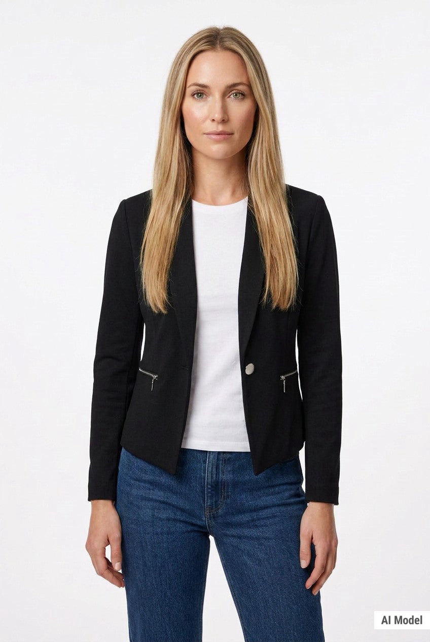 Black cropped collarless crepe jacket with zip pockets and single button on a blonde woman, front view, styled over a white