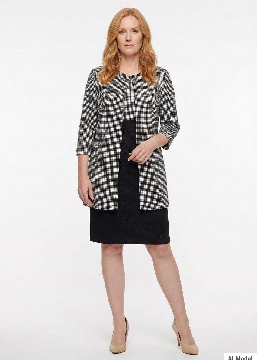 Black-and-white houndstooth 3/4-sleeve jacket over a black knee-length sheath dress, worn by a redheaded woman, front view.