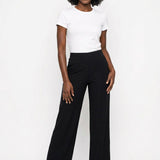 Black wide-leg pull-on palazzo pants with smooth elastic waist, worn by a Black woman, front view, paired with white tee and