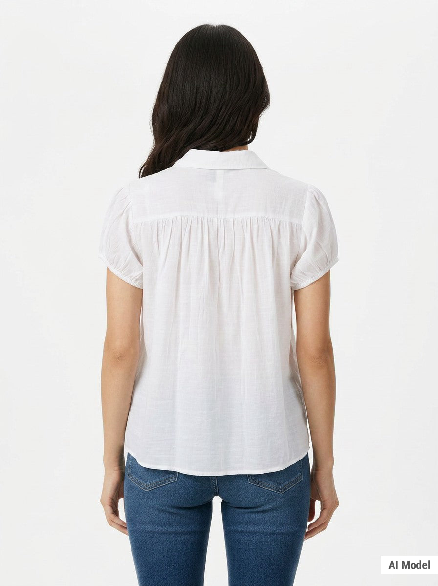 White short-sleeve button-front blouse with gathered yoke and puff sleeves, shown from the back on a dark-haired woman