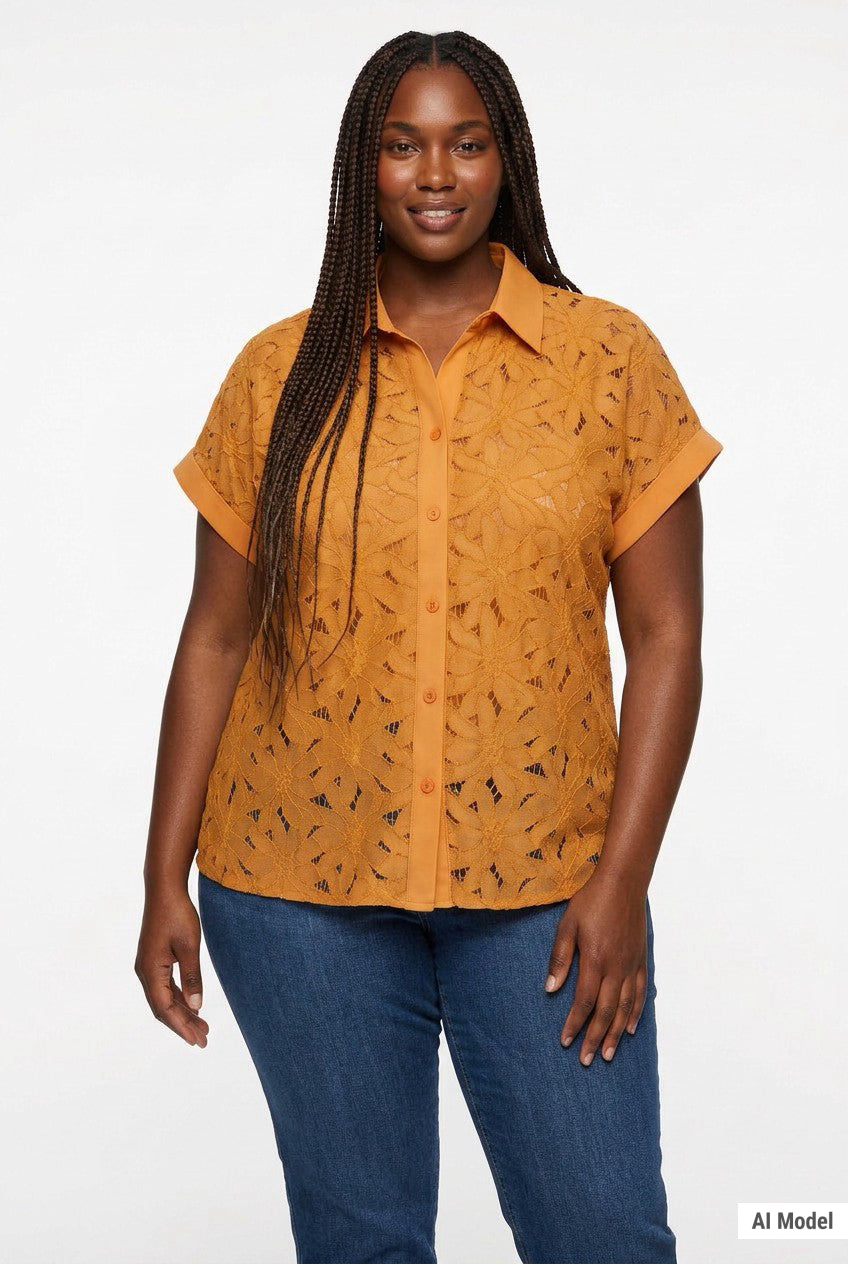 Plus-size model wears a golden orange short-sleeve eyelet button-front blouse with floral cutwork and cuffed sleeves; front