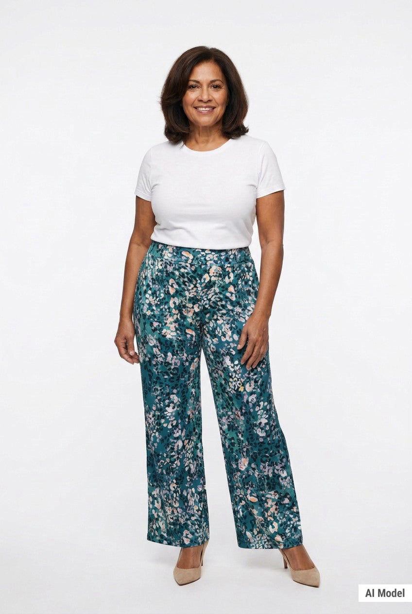 Teal floral wide-leg pull-on pants worn by a plus-size woman in her 60s, front view, paired with a white tee and nude heels.