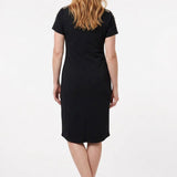 Back view of a woman wearing a black short-sleeve sheath dress with embellished shoulders, knee-length hem, and center back