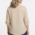 Back view of a woman wearing a tan and white striped roll-tab 3/4 sleeve button-front blouse with blue jeans.
