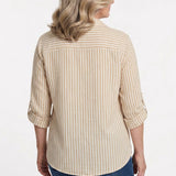 Back view of a woman wearing a tan and white striped roll-tab 3/4 sleeve button-front blouse with blue jeans.