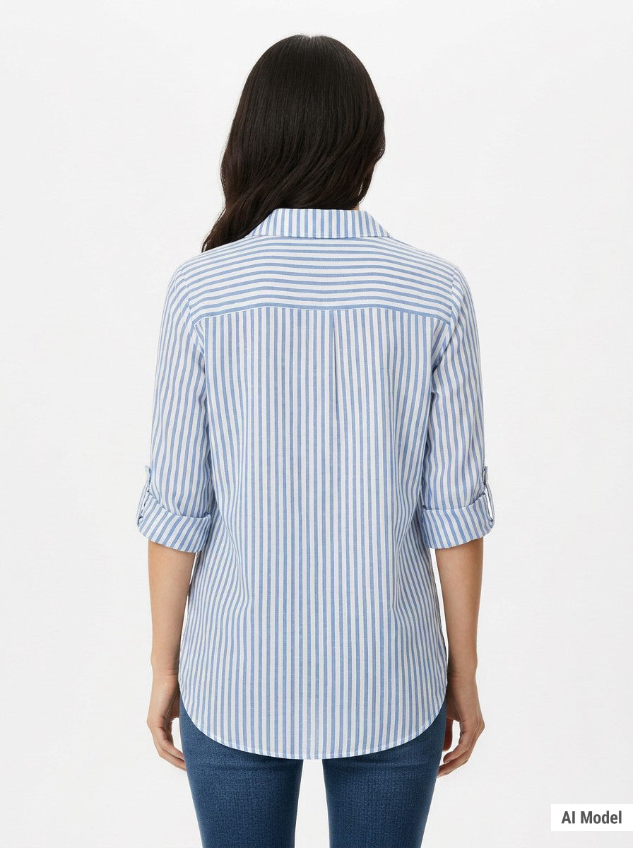 Back view of a woman wearing a blue and white vertical-stripe button-front blouse with rolled 3/4 sleeves and a back yoke,