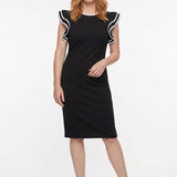 Black knee-length sheath dress with flutter sleeves and white contrast tipping at neckline and sleeve edges, worn by a