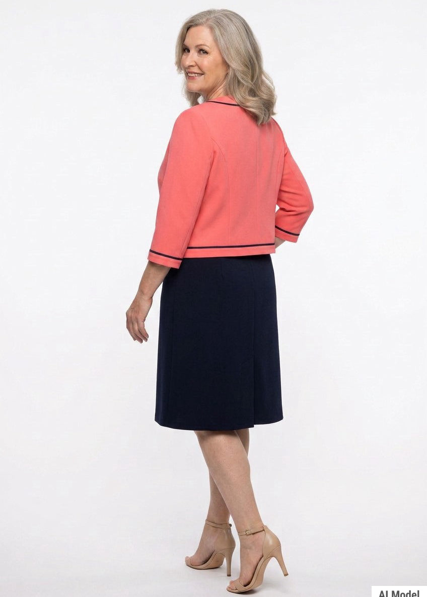 Plus-size model shown from back wearing a coral 3/4-sleeve cropped jacket with navy trim over a navy knee-length A-line