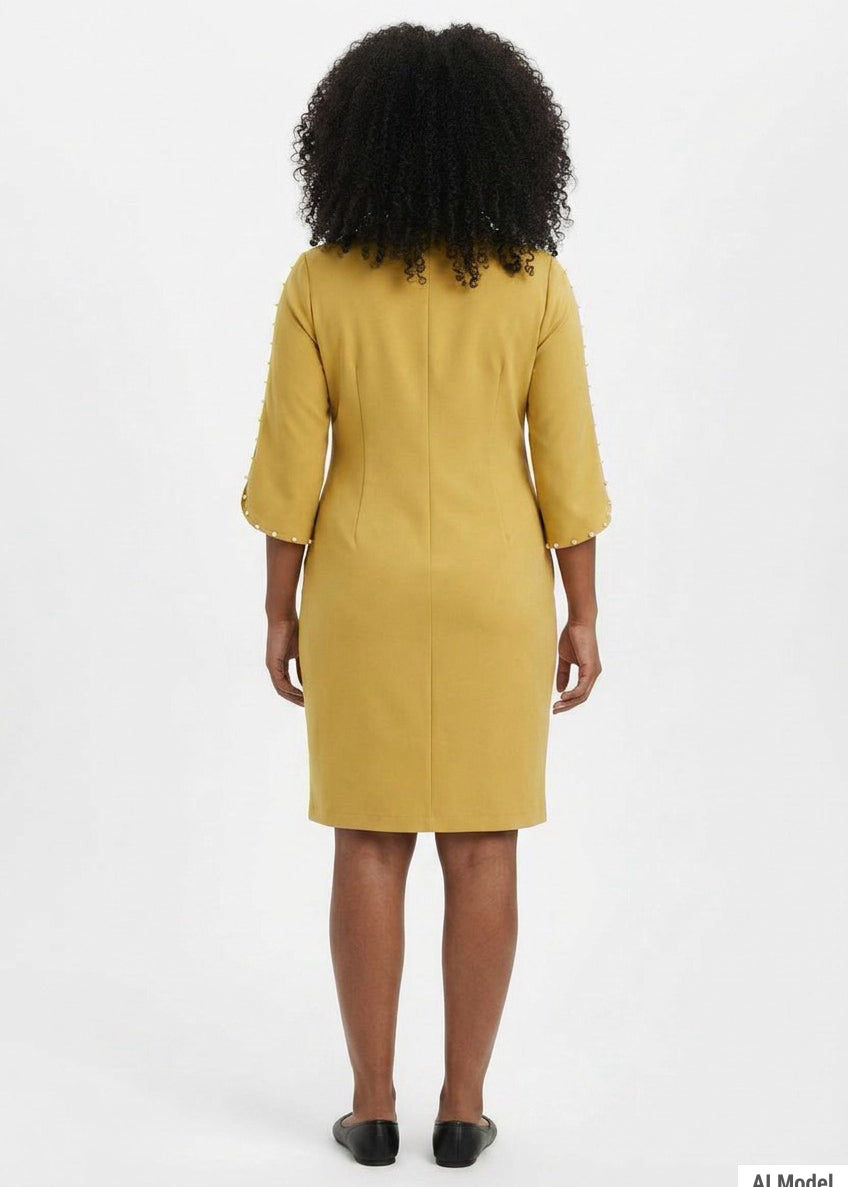 Woman wearing a mustard yellow sheath dress with 3/4 petal sleeves trimmed with pearl details; back view, knee length.