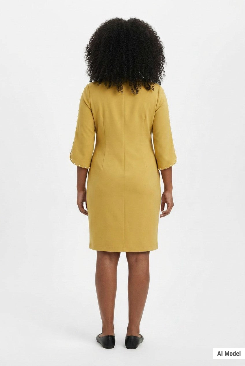 Woman wearing a mustard yellow sheath dress with 3/4 petal sleeves trimmed with pearl details; back view, knee length.