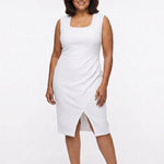 Plus-size model wears white sleeveless square-neck sheath dress with waist band, faux-wrap pleating, and front slit; full