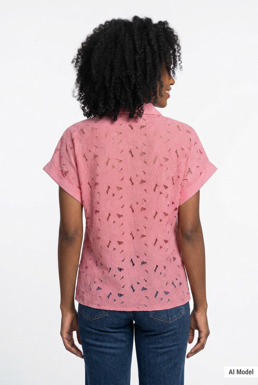 Woman shown from back wearing a pink short-sleeve eyelet button-front blouse with floral cutwork detail, paired with dark