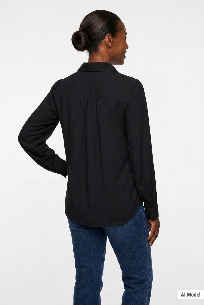 Black long-sleeve satin blouse with puff shoulders, back yoke with gathers, and button cuffs, on a woman with a bun, rear