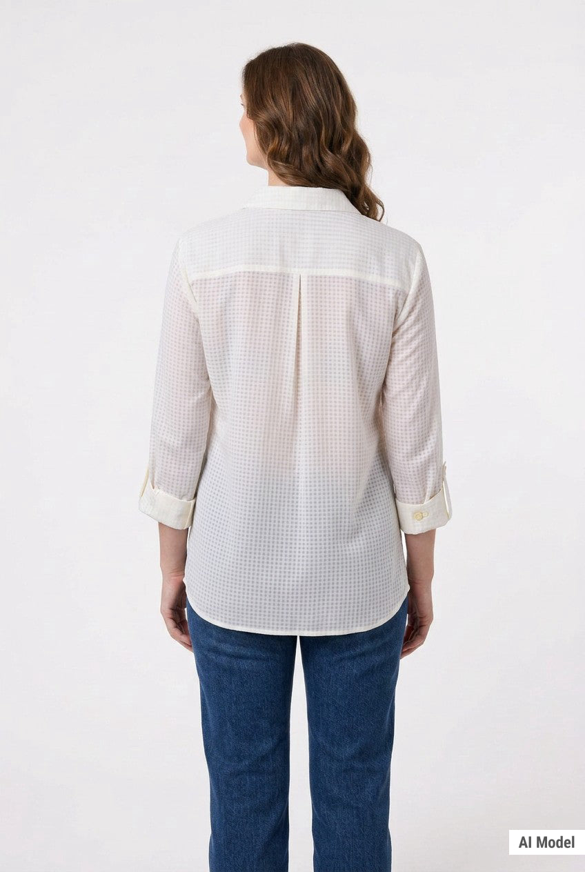 Woman's back view showing ivory windowpane button-front blouse with rolled 3/4 sleeves, back pleat, and blue jeans.