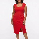 Red sleeveless square-neck sheath dress with high-waist band, faux-wrap pleating, and front slit, on a plus-size model, full