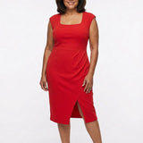 Red sleeveless square-neck sheath dress with high-waist band, faux-wrap pleating, and front slit, on a plus-size model, full
