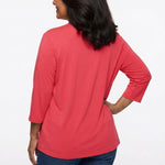 Back view of a woman wearing a coral red 3/4-sleeve solid cardigan with a relaxed fit, paired with dark blue jeans.