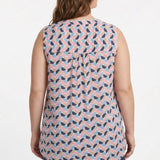 Plus-size model wearing a sleeveless blouse with geometric half-moon print in navy, pink, blue, and tan, with back pintuck