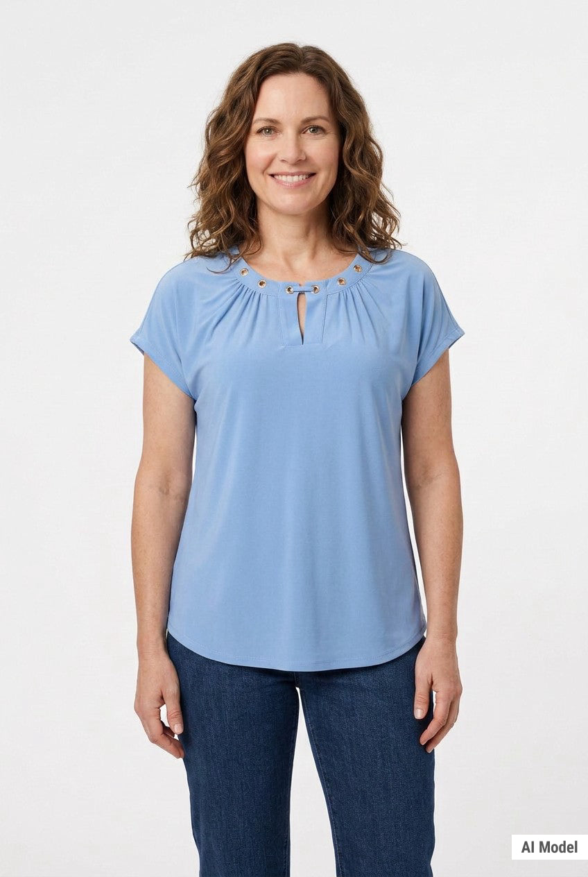 Front view of a woman wearing a light blue short-sleeve knit top with gold grommet-accented gathered neckline and keyhole