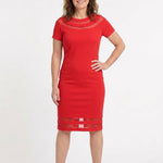 Red short-sleeve sheath dress with sheer mesh insets at neckline and hem, worn by a woman with brown hair, front view.