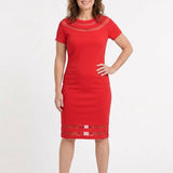 Red short-sleeve sheath dress with sheer mesh insets at neckline and hem, worn by a woman with brown hair, front view.