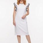 White sheath dress with double ruffle sleeves and black contrast tipping at neckline, worn by a red-haired woman, full front