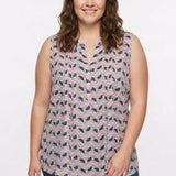 Plus-size model wears a sleeveless pintucked blouse in a multicolor half-moon geometric print with a split neckline and