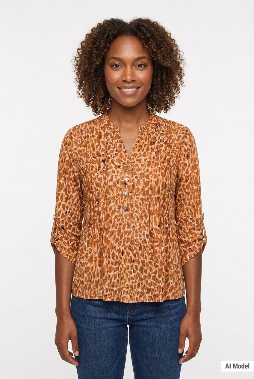 Woman wearing a brown leopard-print 3/4 roll-tab sleeve pullover top with Y-neck button detail, paired with dark jeans,